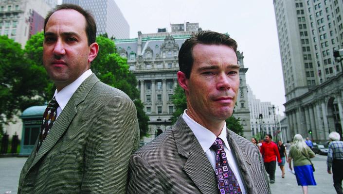 Jon Vernick and Daniel Webster stand back to back on a Baltimore street