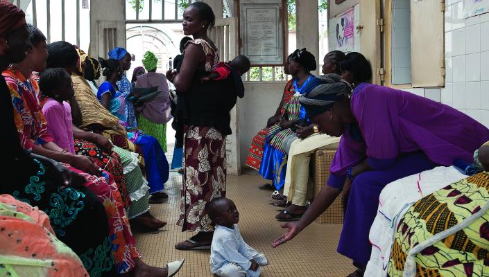 Women, seated and standing, in a clinic waiting room