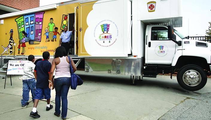 A family of 3 approaches the CARES van