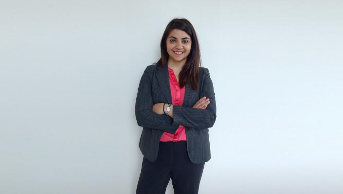 Guarvika Nayyar stands with her arms folded across her chest