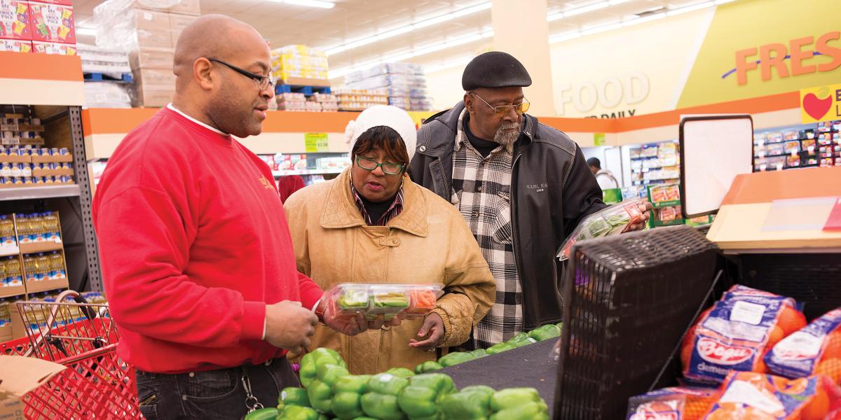 Theodora and Eugene Morris (married for 45 years) discuss the bell peppers with Food Depot produce manager Dominic Wilson.