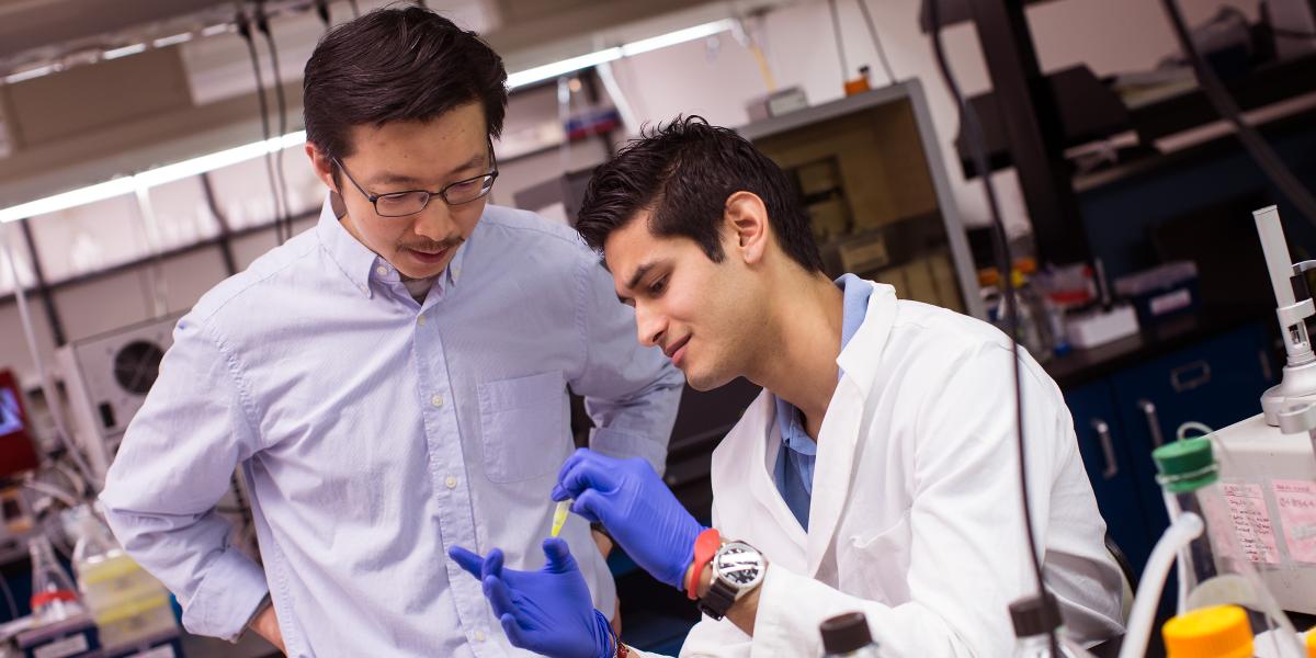 Jiou Wang and a student in his lab