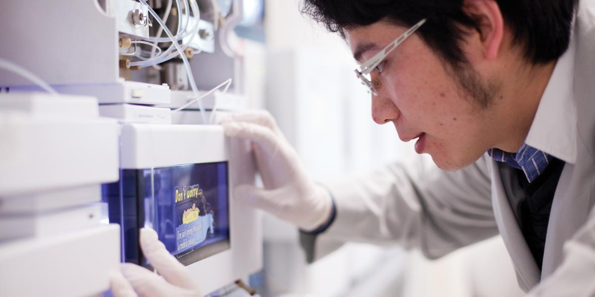 Postdoc Dingyin Tao in the lab with Rhoel Dinglasan