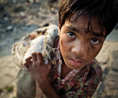 12 year-old-boy scavenging in Bangladesh.