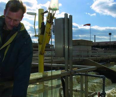 Rolf Halden takes a water sample at a treatment plant