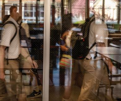 student walking past window